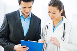 A doctor reviews lab results with a patient. 